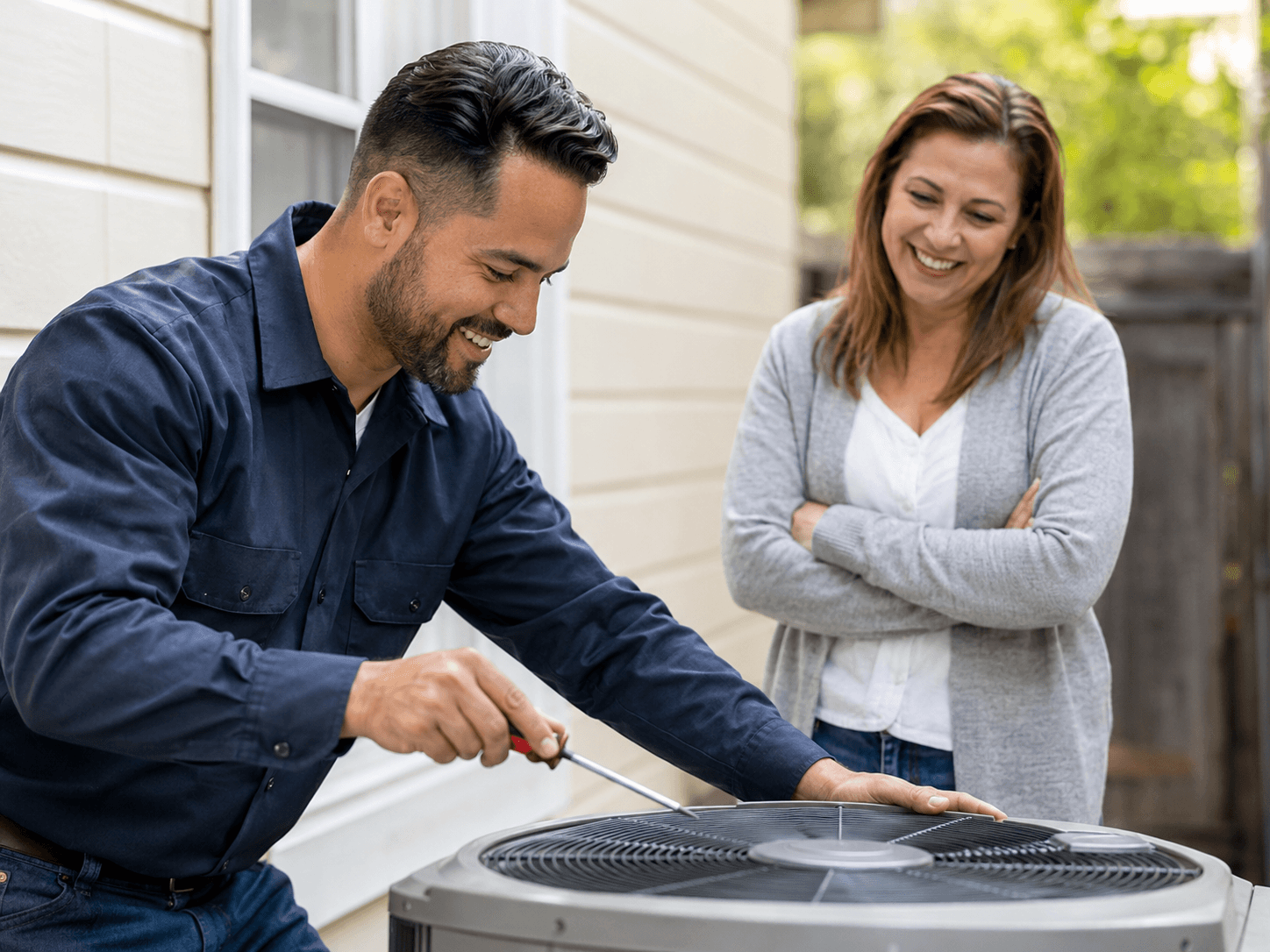 HVAC technician servicing a home air conditioning system